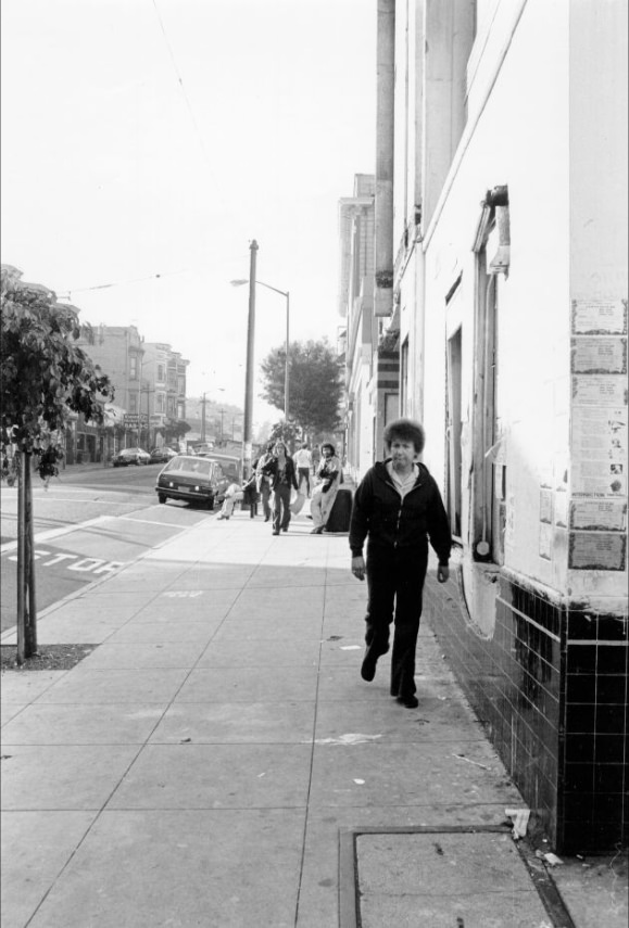 Woman walking by the Haight Street Theater on Haight Street at Cole, 1977.