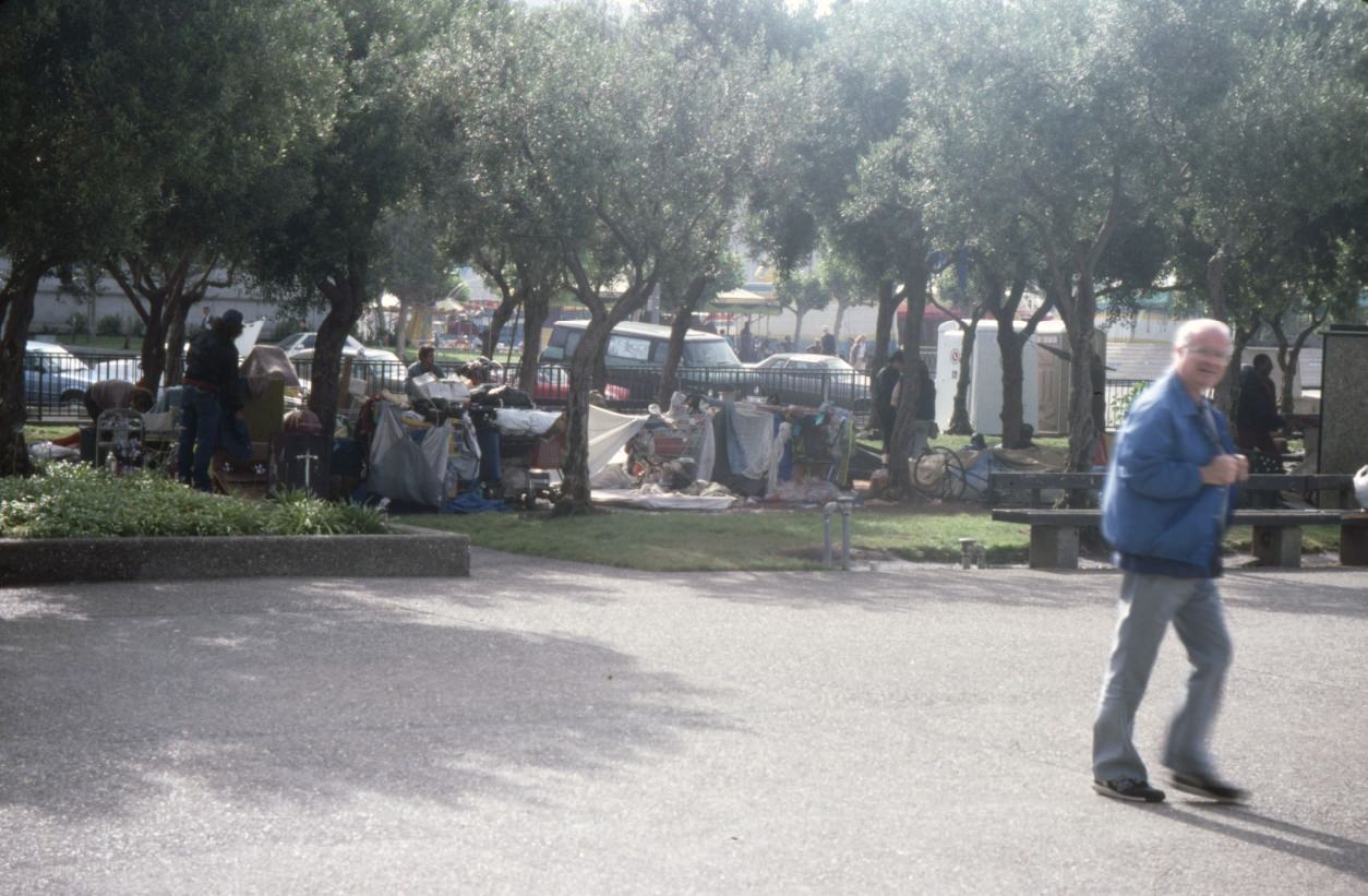 Encampment of homeless people at Civic Center Plaza next to festival, 1989.