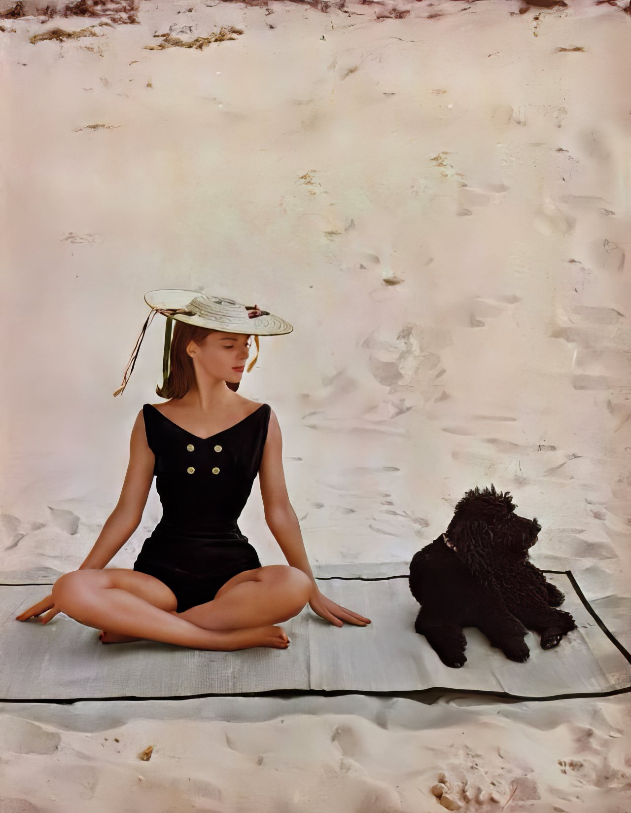 Model in a black knit bathing suit by Sportwhirl, Harper's Bazaar U.S., December 1956.