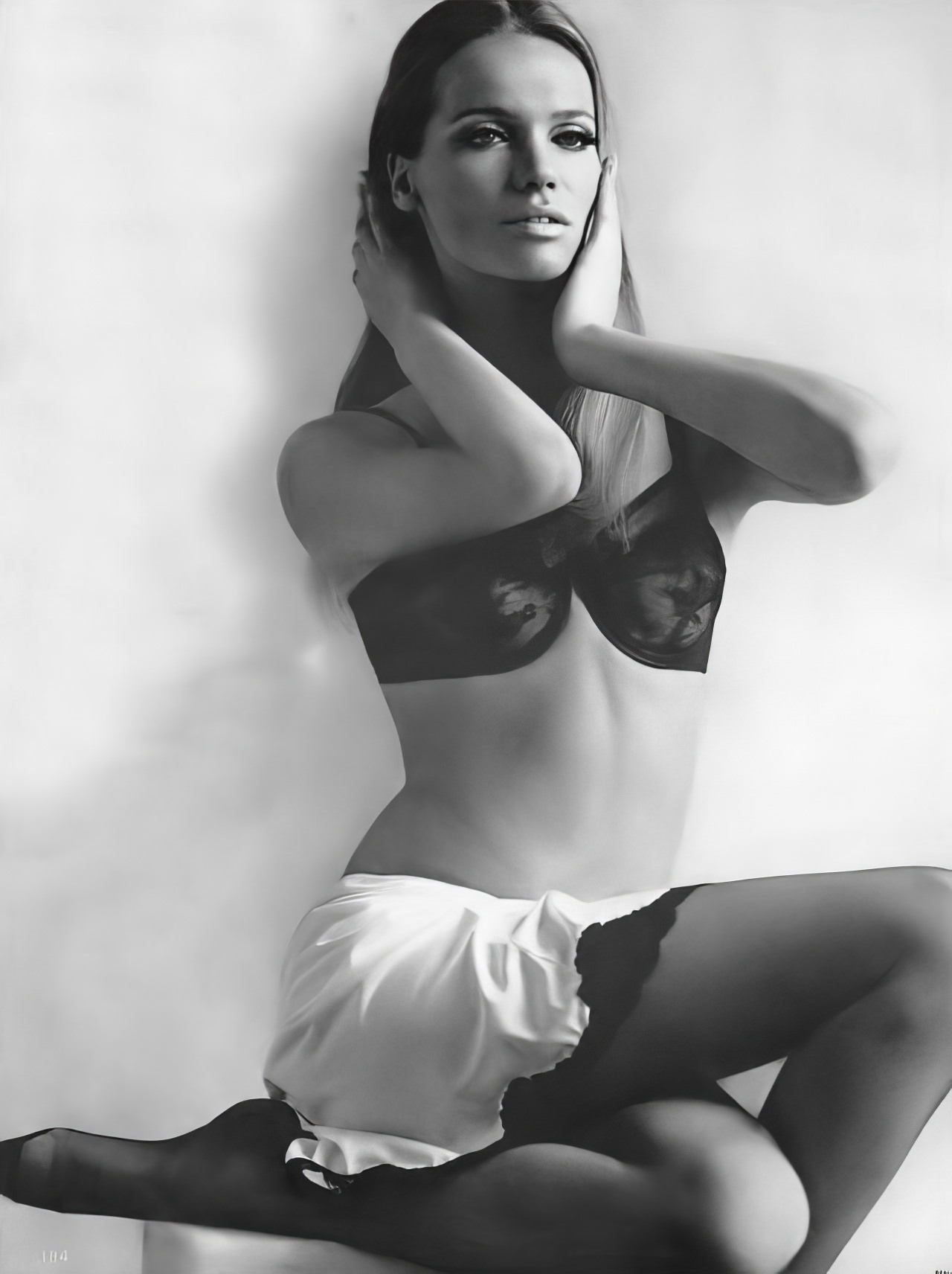 Veruschka in a black lace bra and white slip by Maidenform and Kickernick, Vogue, March 1, 1966.