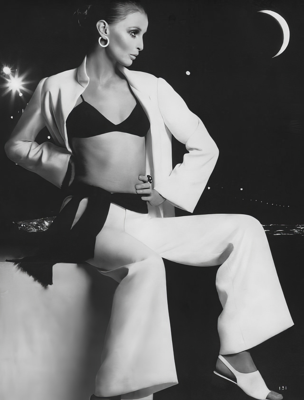 Samantha Jones in a white crêpe dinner pantsuit by Sport Sophisticates, Vogue, November 15, 1968.