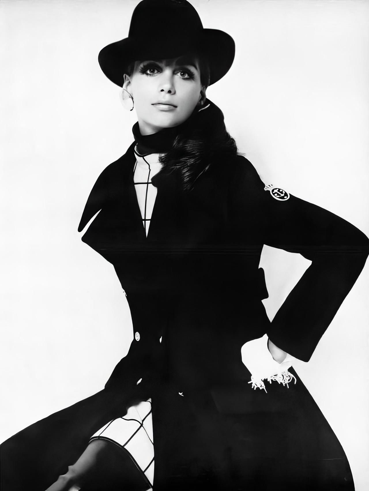 Windsor Elliott in a black wool coat and dress by Bill Blass for Maurice Rentner, Vogue, October 15, 1968.