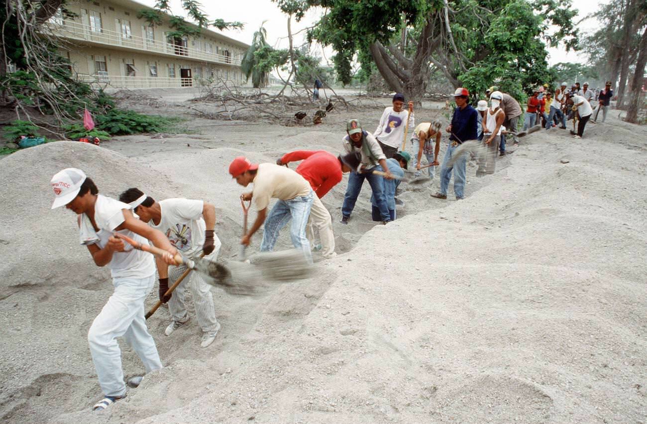 Filipino workers clear volcanic ash from a drainage ditch at Clark Air Base, Luzon