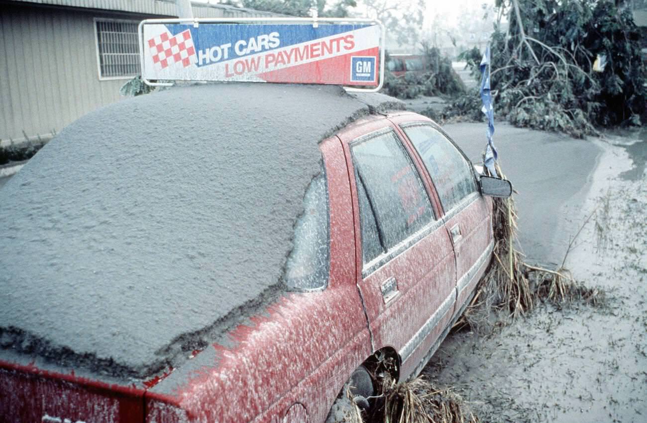 A vehicle covered in ash in the Philippines after Mount Pinatubo's eruption, with over 20,000 evacuees removed as part of Operation Fiery Vigil.