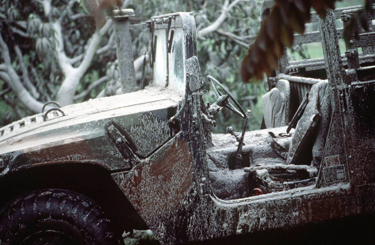 An M998 HMMWV covered in ash at Papaga Agricultural College, Philippines, after Mount Pinatubo's eruption, with over 20,000 evacuees removed.