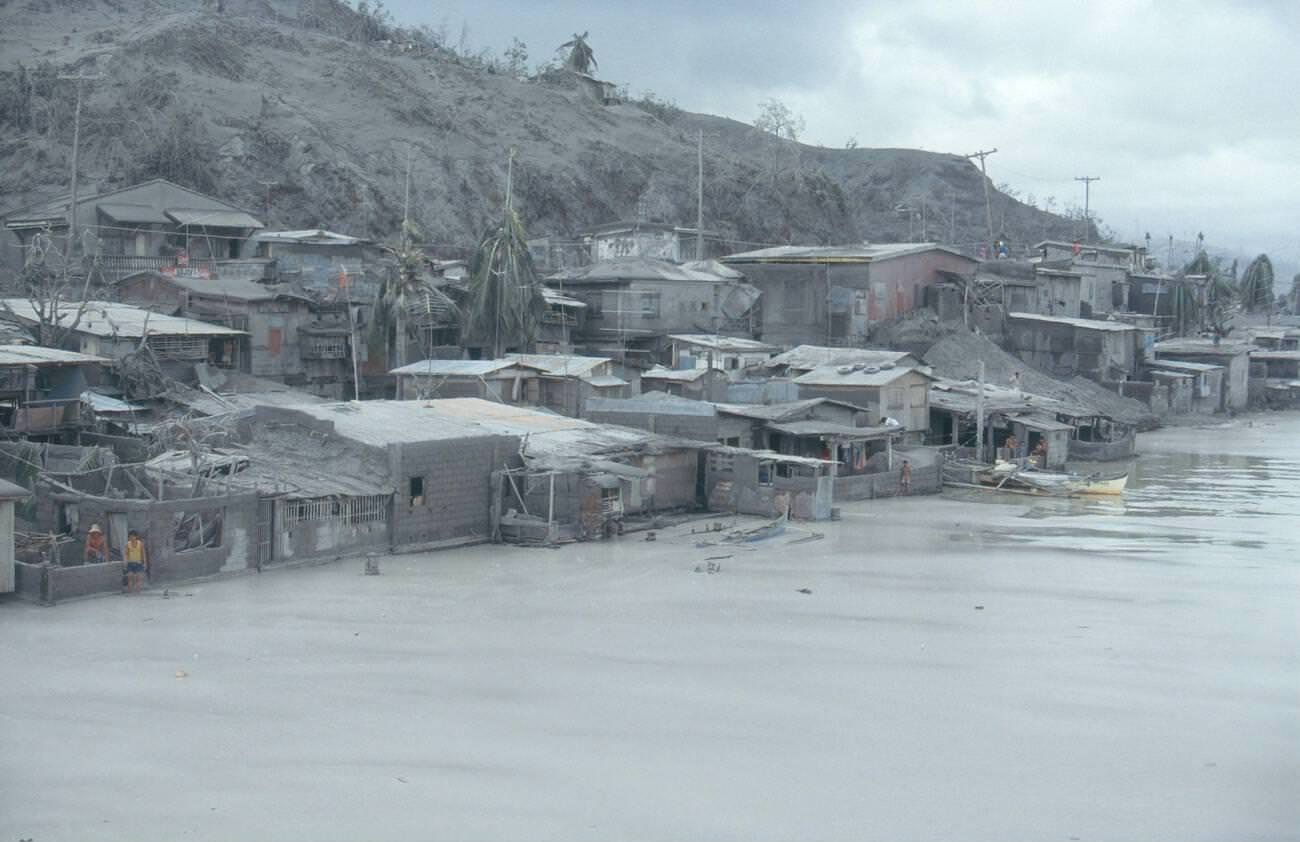 A village on Subic Bay's coastline, Philippines, blanketed in ash following Mount Pinatubo's eruption.