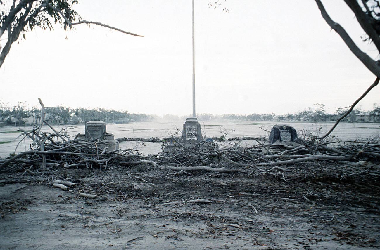 The 13th Air Force parade ground at Clark Air Base, Luzon, Philippines, with damaged trees and an ash-covered landscape after Mount Pinatubo's eruption.