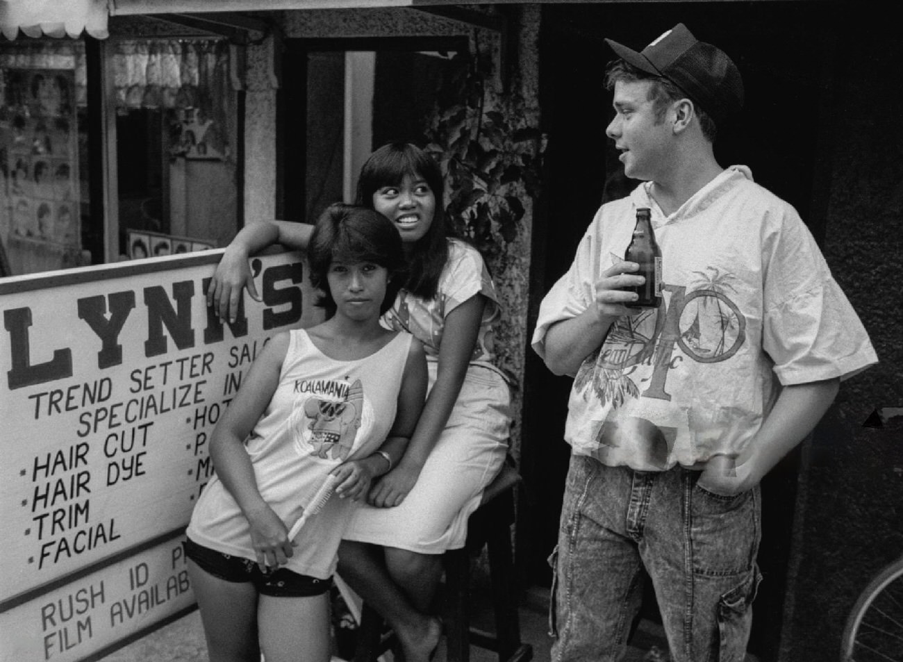 A U.S. Marine with two young women at Clark Air Base, Philippines, May 1988.