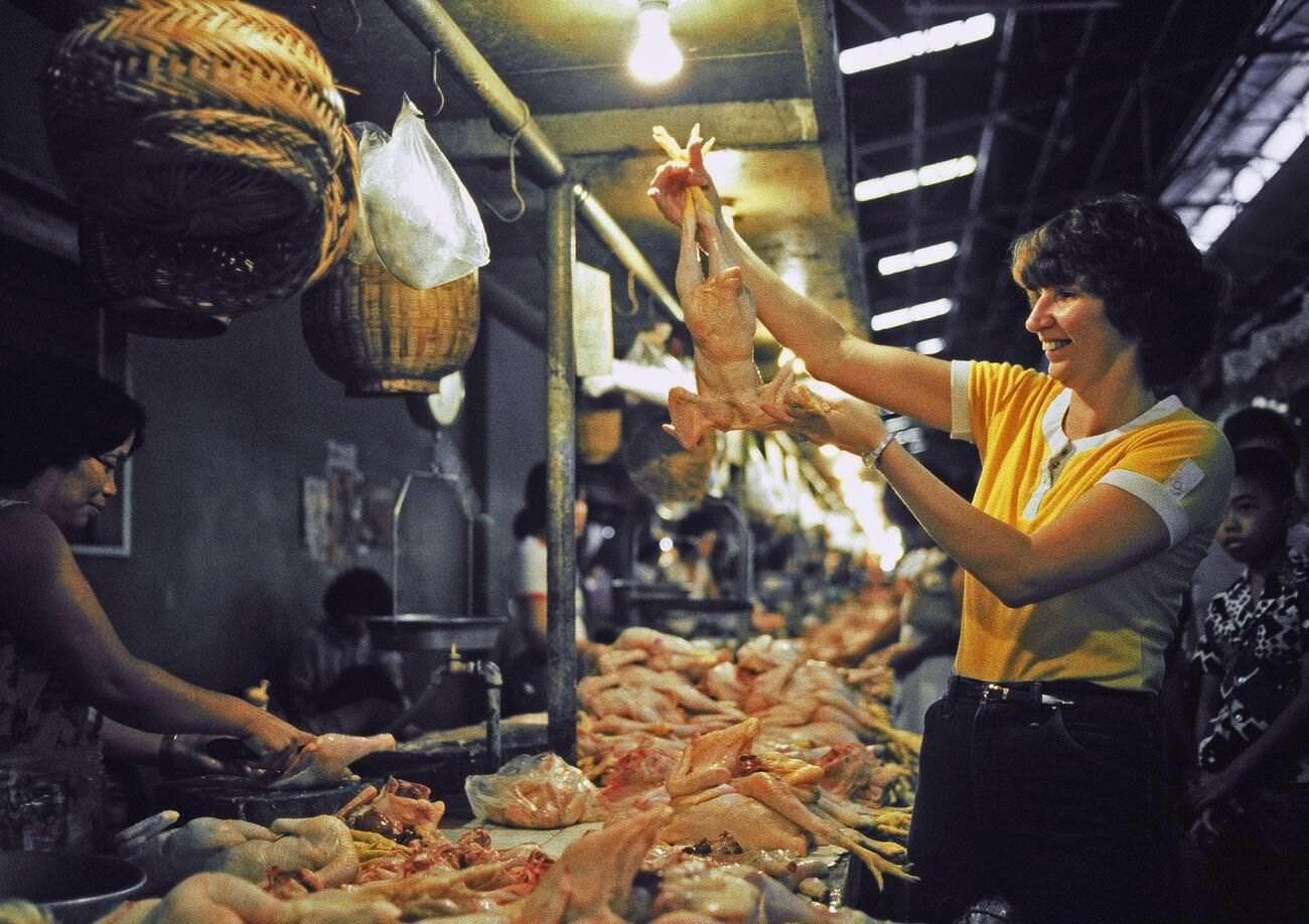 A dependent wife shopping for poultry in the Philippines, 1982.