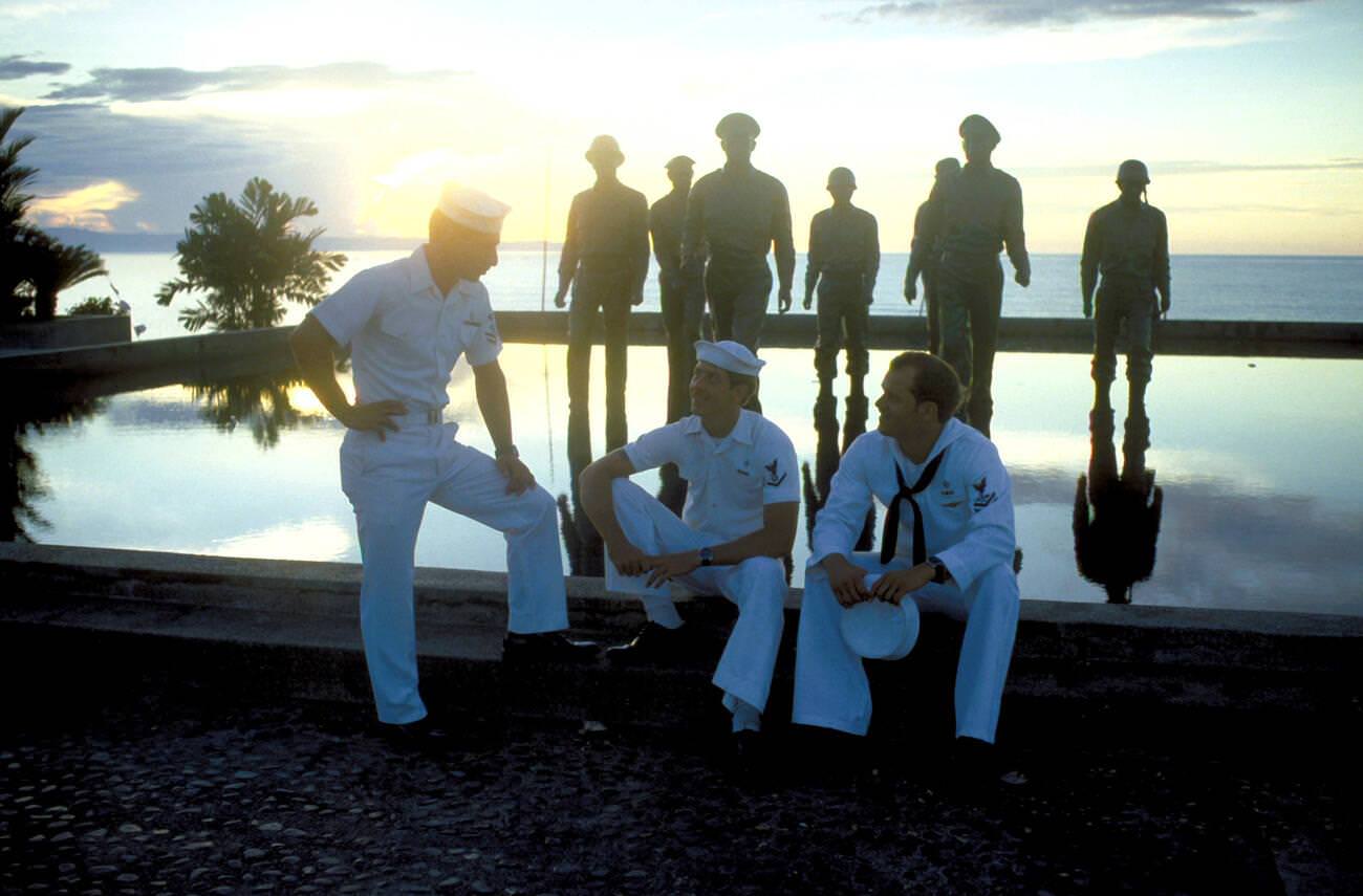 Crewmen from USS CONSERVER relax by a monument to GEN Douglas MacArthur, 1981.