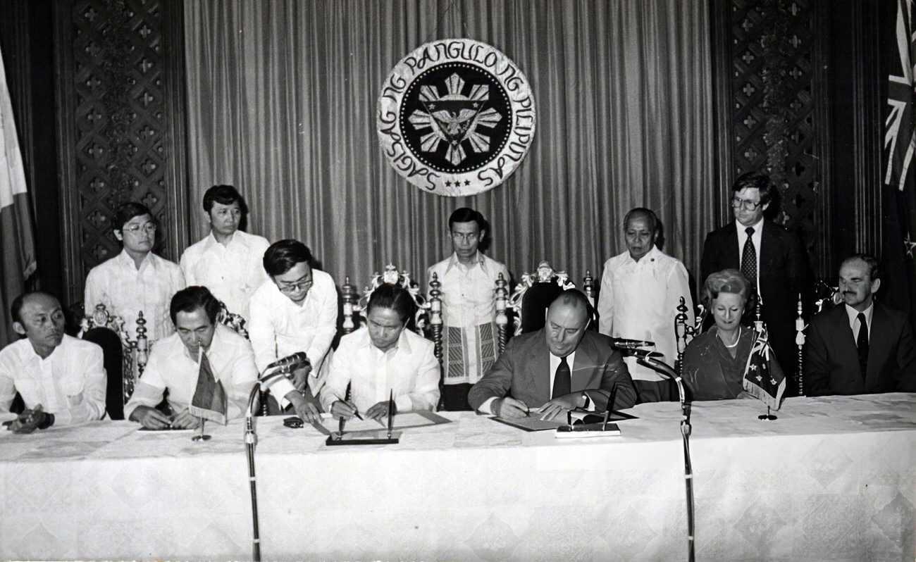 President Ferdinand Marcos and New Zealand Prime Minister Robert Muldoon sign an energy agreement at Malacanang Palace, Manila, Philippines, 1980.