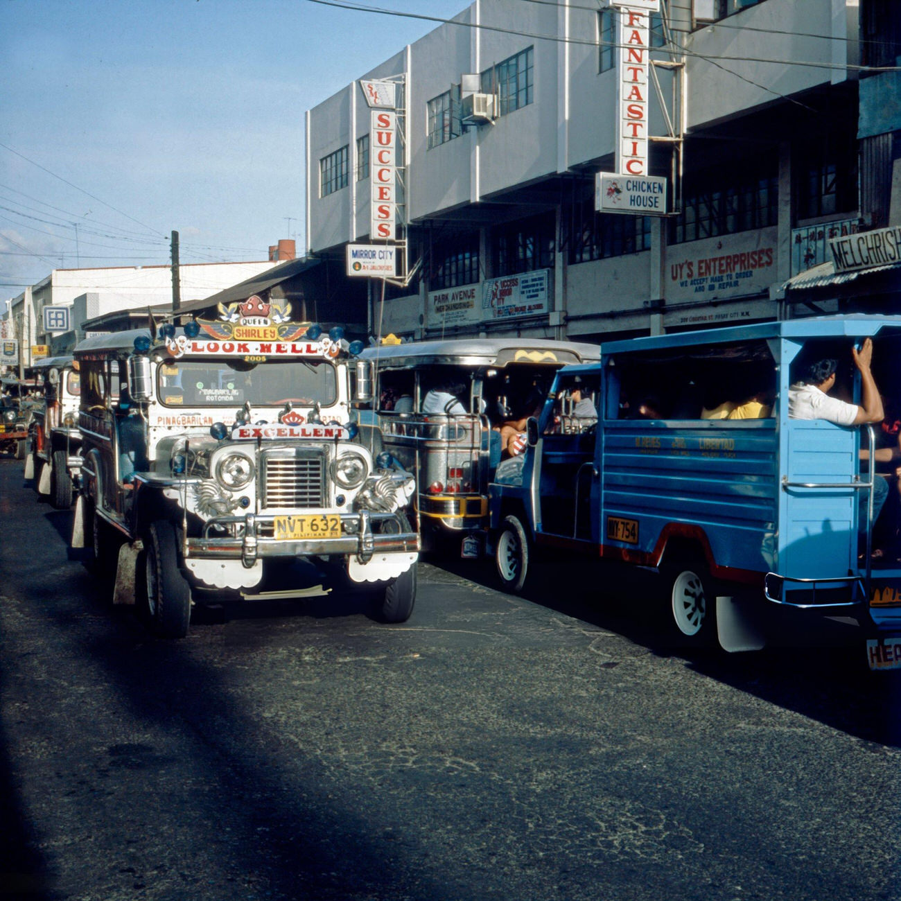 Jeepney minibuses navigate through Manila's streets, Philippines, in the early 1980s.