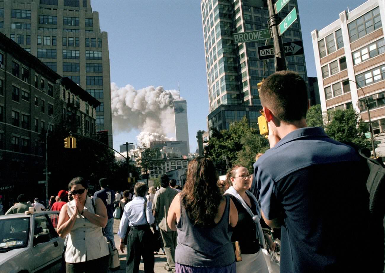 Workers watch from Sixth Ave in Soho as the towers collapse