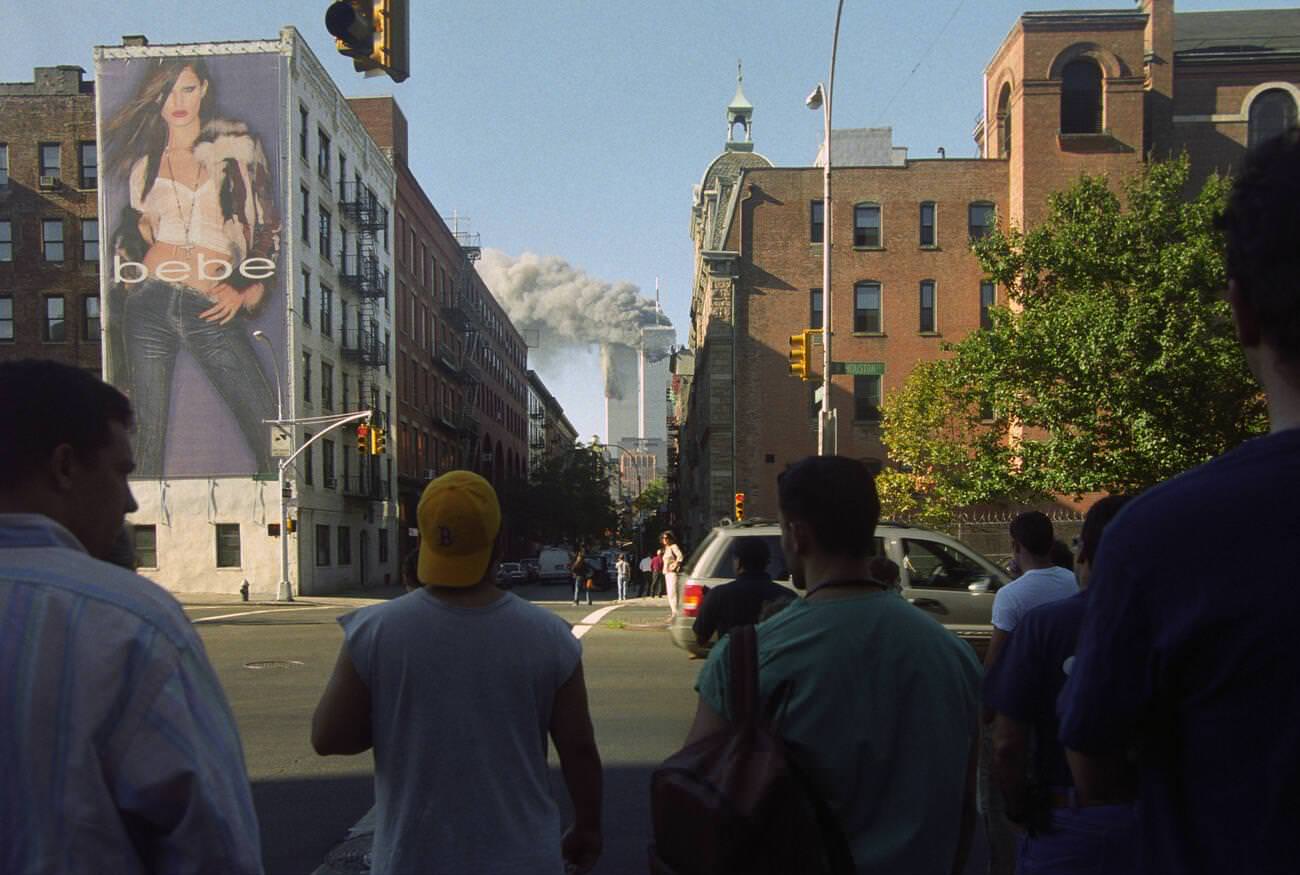 New Yorkers watch the twin towers of the World Trade Center burn from Houston & Thompson Streets.