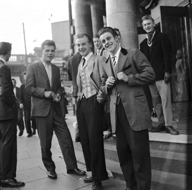 A ‘teddy boy’ shows off his suit to friends, 1955.