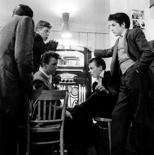 A group of Teddy Boys congregate around a jukebox, London, England, July 1955. o.
