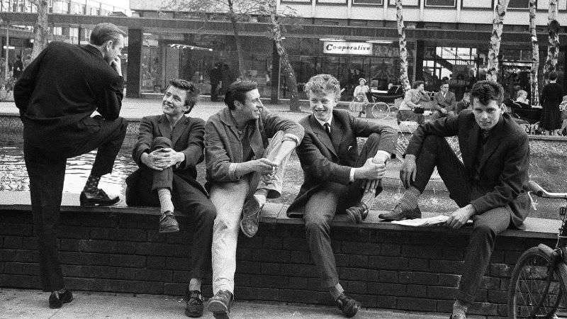 The boys of Stevenage in Hertfordshire beating their nightly battle with boredom in the town square, October 1959.