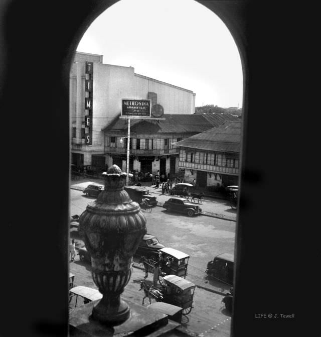 Looking east across Quezon Blvd. with Times Movie Theater from the east tower of the church, Quiapo Church, Manila, Philippines, May 1945