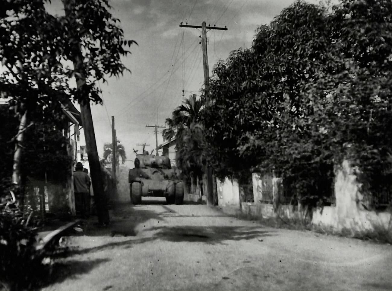 Tanks from the 1st Cavalry position for an offensive against Japanese forces at Rizal Stadium, aiming to secure the Walled City of Intramuros in Manila, 1945.