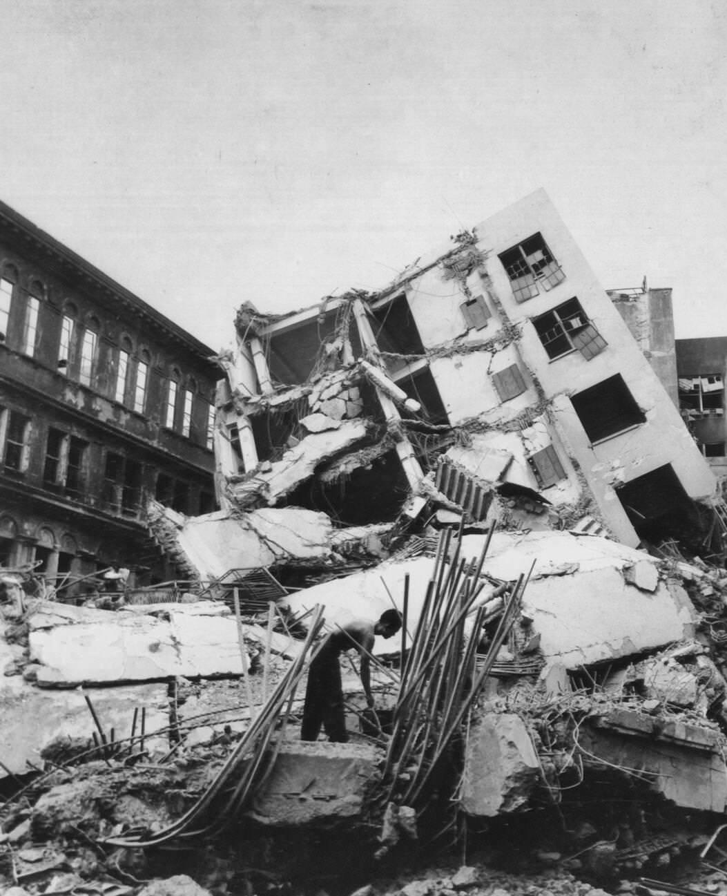 A building on the Escolta in Manila is dislodged and tipped over by an explosion during the battle for Manila, 1945.