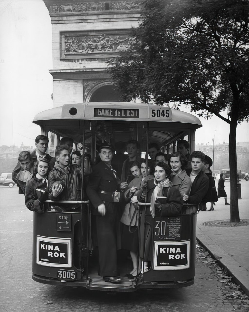 American faces on a Paris bus look unaffected by the French environment. This group, which is headed toward the Arc de Triomphe, is going home from Saturday afternoon football game in the Bois.