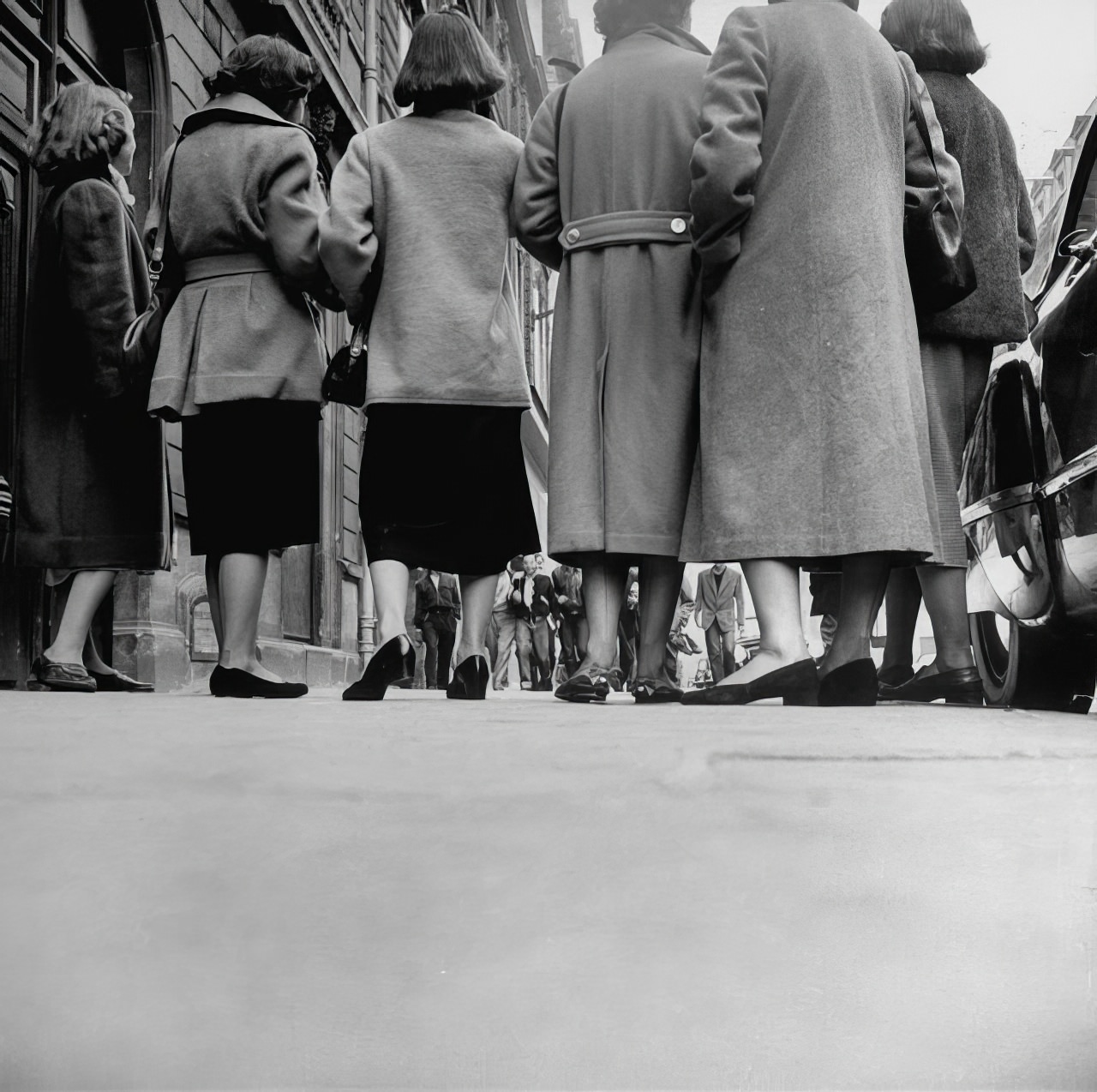 American feet on Paris street are shod in the same sort of low-heeled shoes that identify teen-agers at home. But this group goes along with Paris styles and usually wears nylons instead of bobby sox.