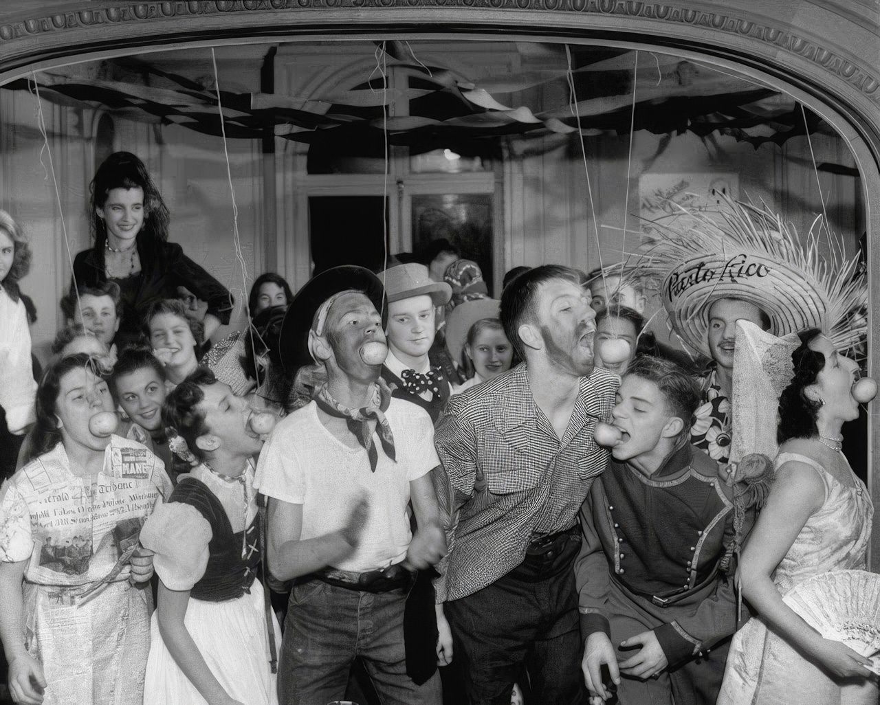 In costumes full of international flavor, teen-agers snap at apples at school party.