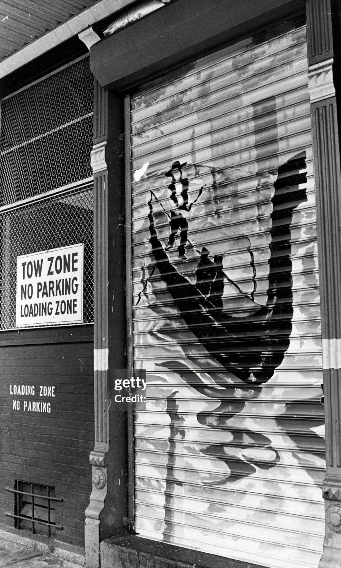 Graffiti of a man on a gondola graces a loading zone door in Boston's North End, 1978.