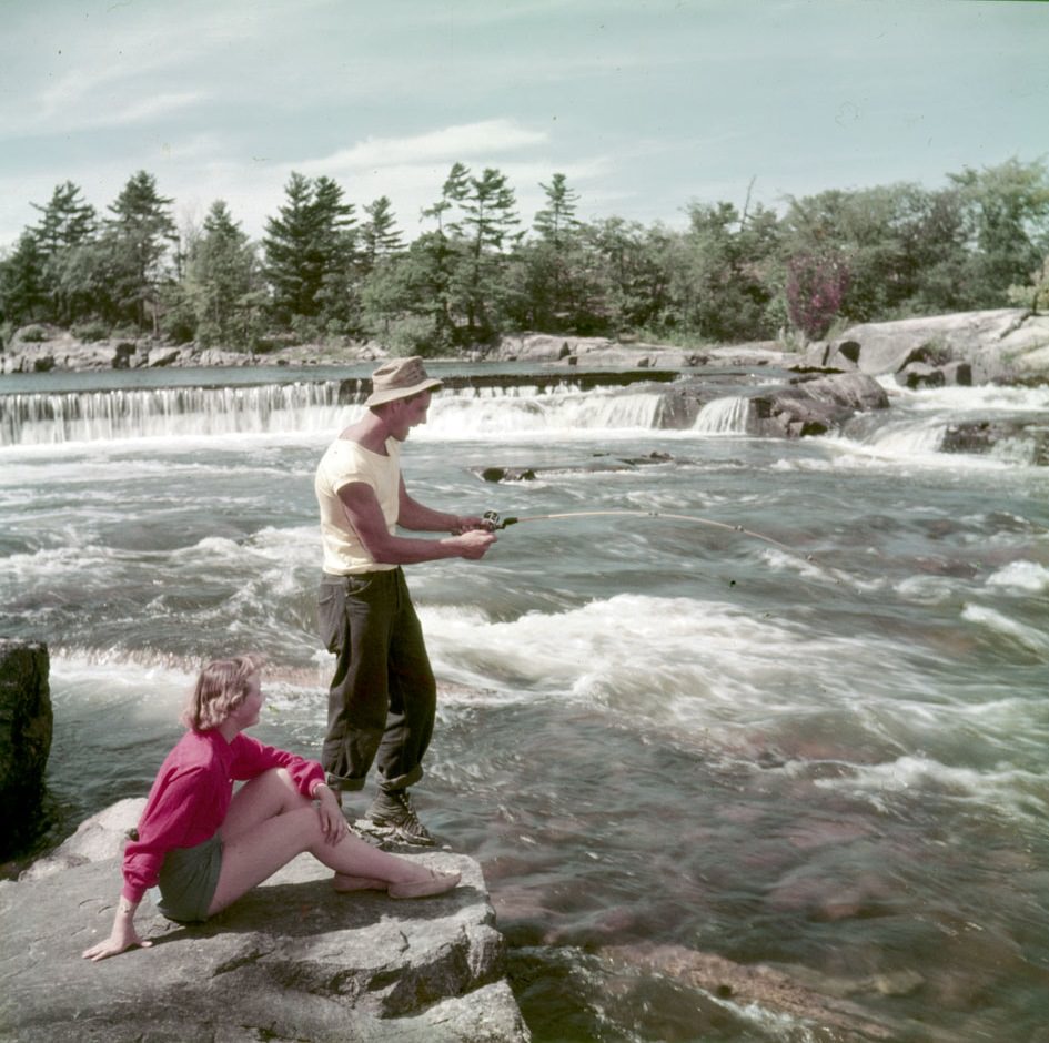 A couple fishing from rocks at Burleigh Falls, Ontario
