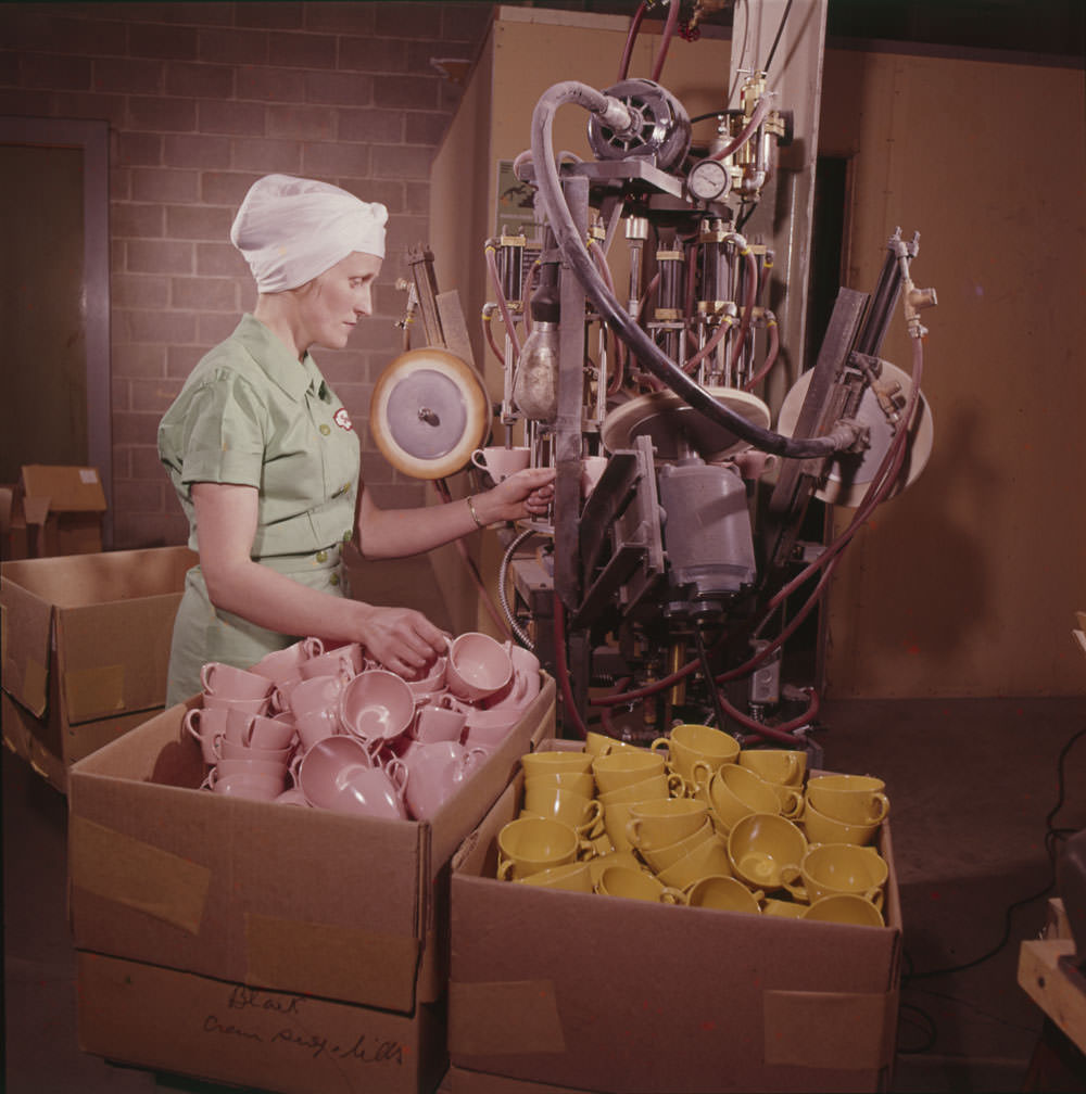 A woman uses machinery to make cups at Maple Leaf Plastics, Toronto, Ontario