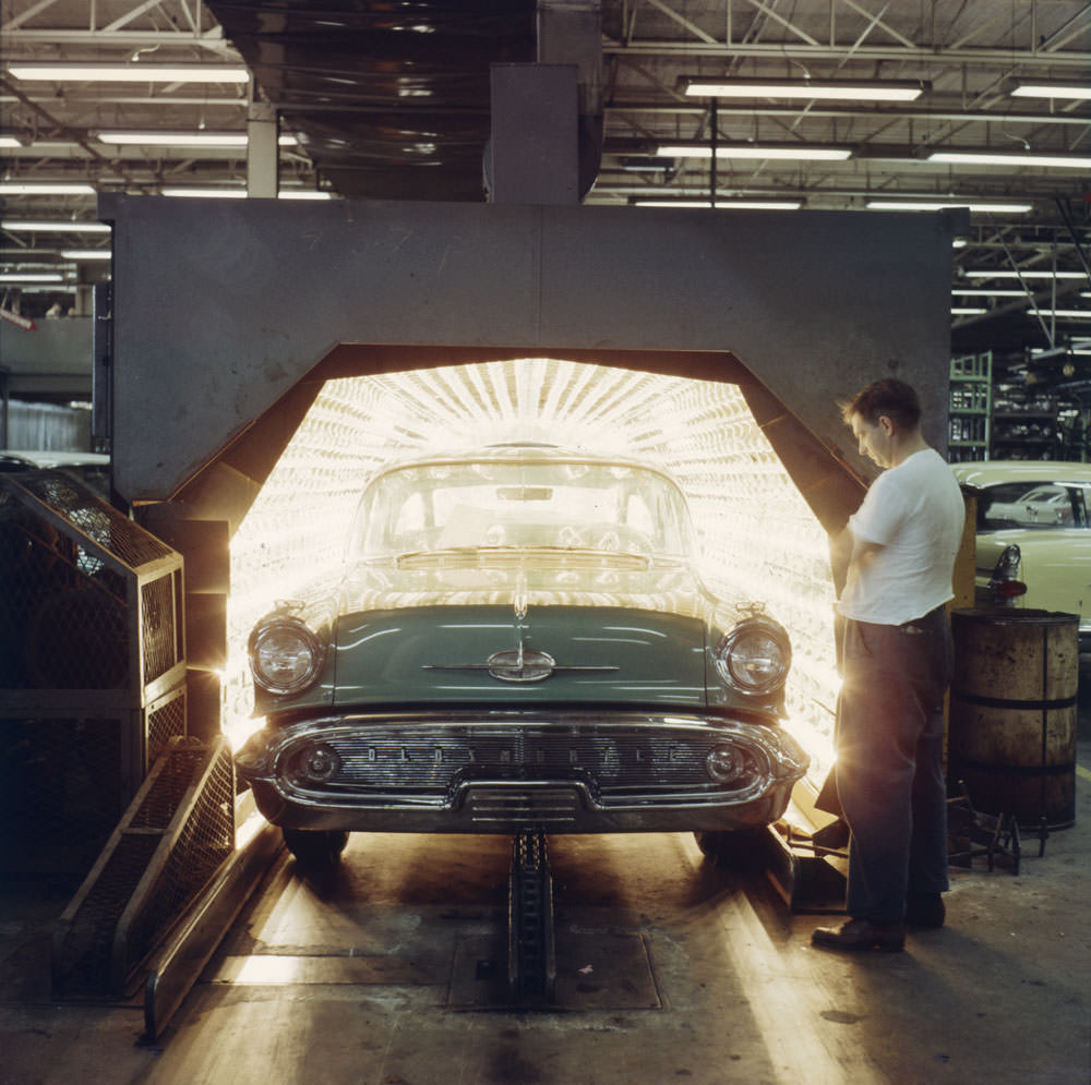 An automobile exits a drying oven after being painted, General Motors, Oshawa, Ontario, 1959