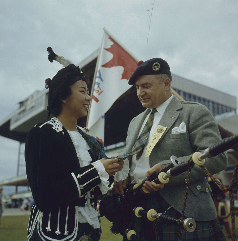 Betty Chan admires Pipe Major Bill MacLeod’s tie, made from the MacLeod tartan, at a festival, Kildonan Park, Winnipeg, Manitoba
