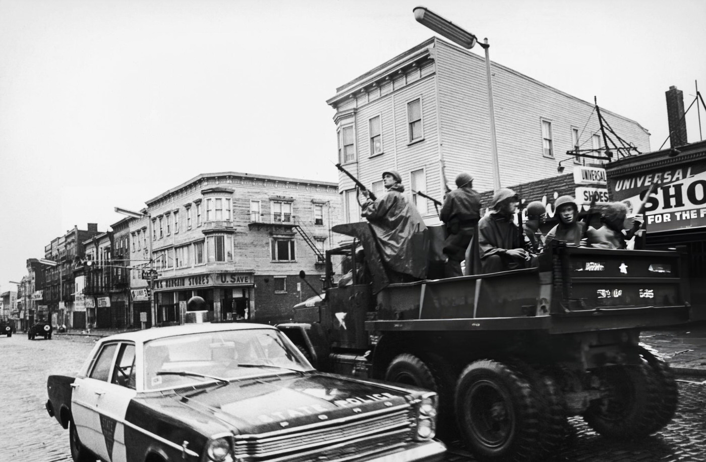 Members of the National Guard join the local police in searching for rooftop snipers