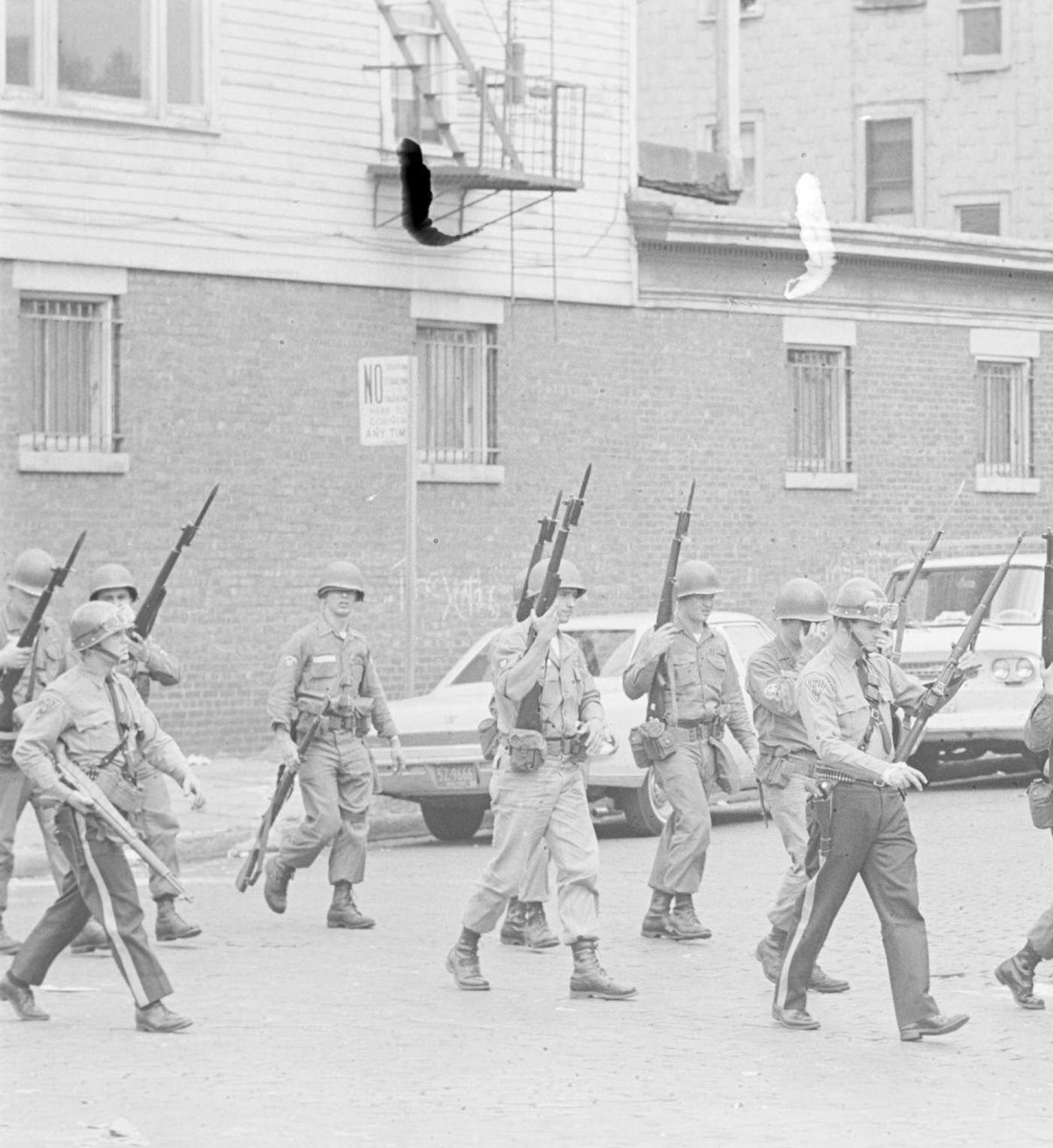 A troop of armed National Guard soldiers and police officers on patrol
