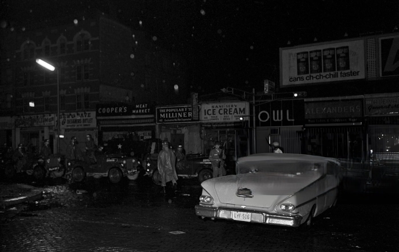 National Guard soldiers on guard at night on a sidewalk