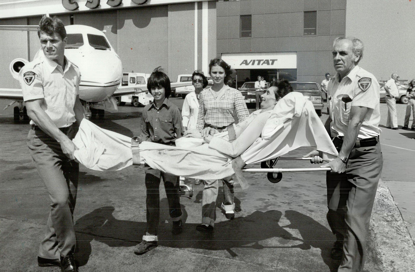 Scarborough mother Shirey Chappell is carried to an air ambulance, 1980s.