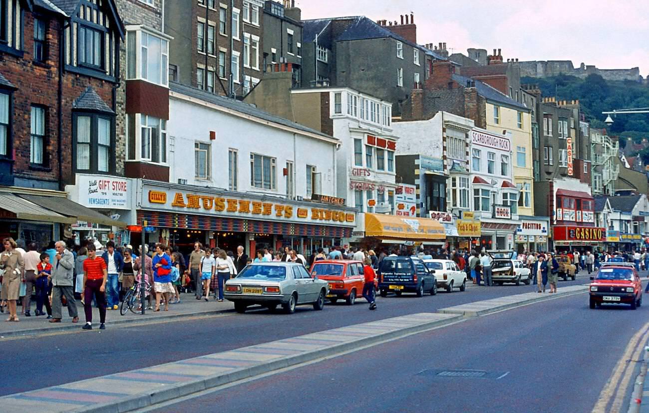 Scarbrough sea front with amusement places and tourists on a summer day in the 1980's