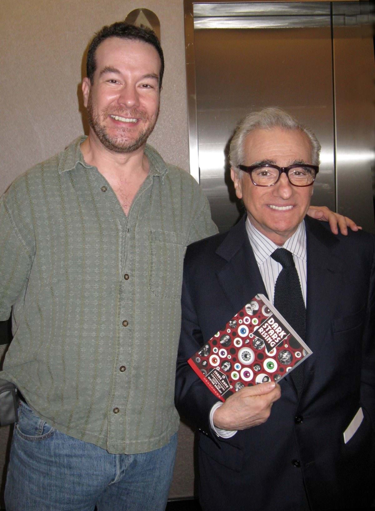 Martin Scorsese holding a copy of Shade Rupe’s book ‘Dark Stars Rising : Conversations from the Outer Realm’.