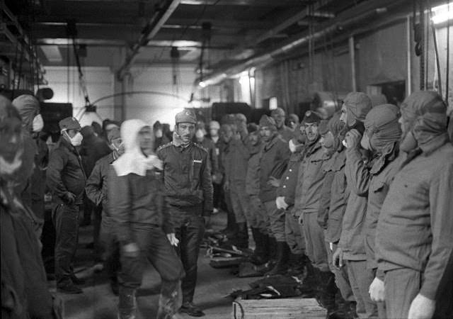 A team of human liquidators prepares to clear radioactive debris off the roof of the No. 4 reactor.