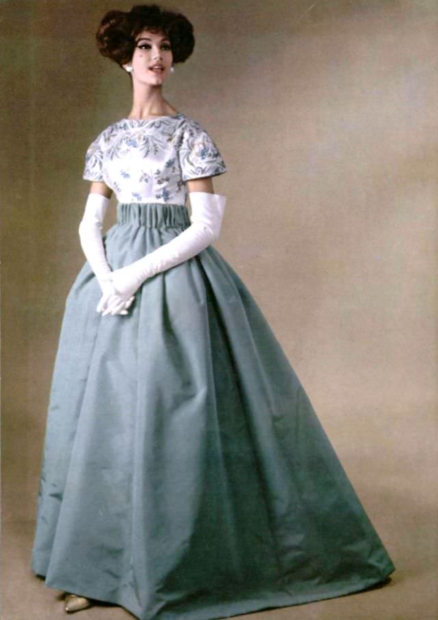 Simone d'Aillencourt in a gala evening gown of silk faille skirt with an embroidered satin top, by Pierre Balmain, 1958.