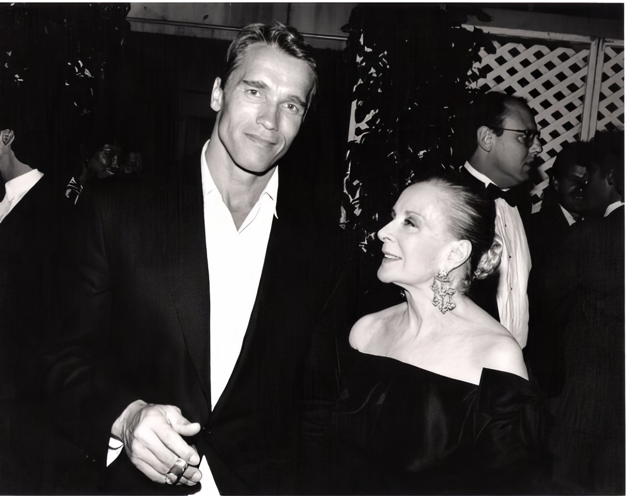 Arnold Schwarzenegger, as handsome as he ever was in his pre-govenor days admired by Mrs. Vincent Minnelli, step-mother of Liza, at a private reception in Beverly Hills.
