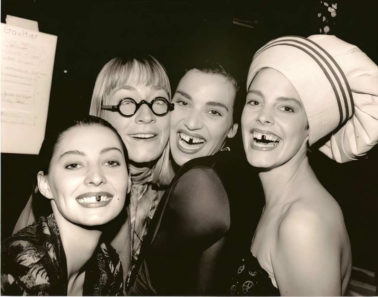 The models (and stylist in glasses) having fun after a fashion show.
