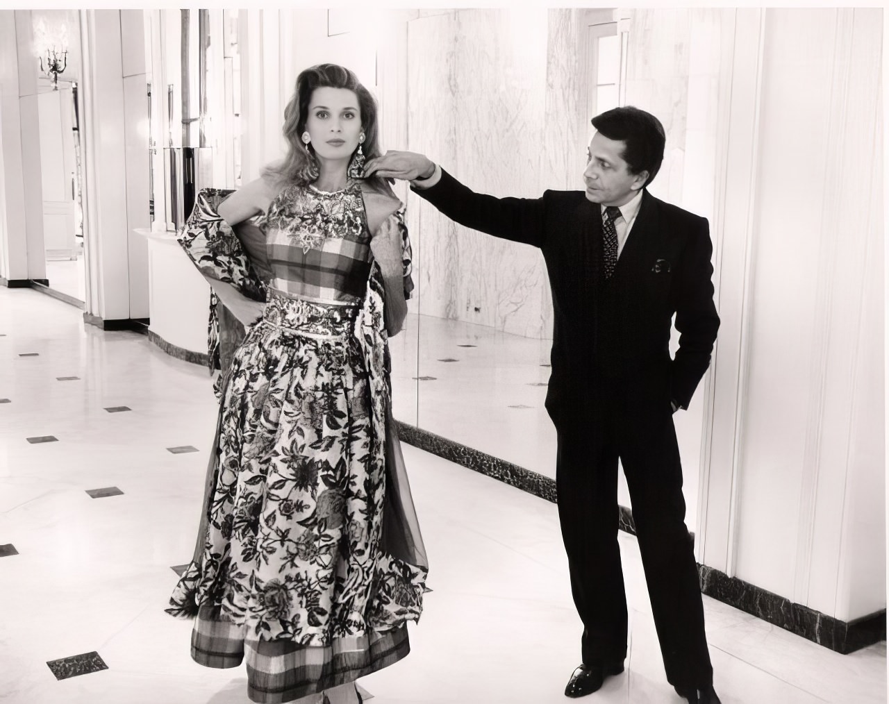 Valentino with model in the lobby of the Beverly Wilshire Hotel during a rare visit to L.A.