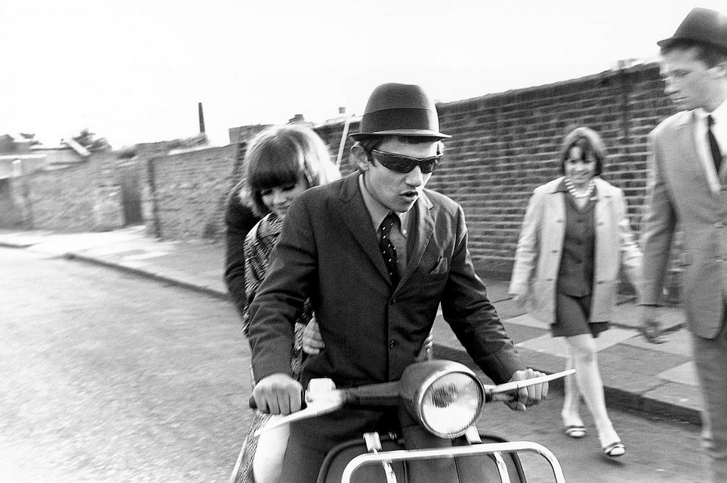 Mods on a scooter.