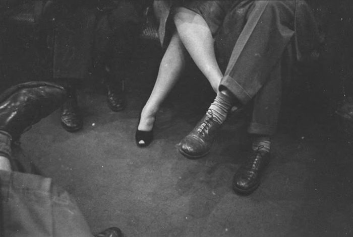 A couple playing footsies on a subway, 1946.