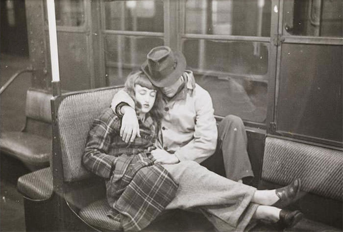 A couple sleeping in a subway car, 1940s.