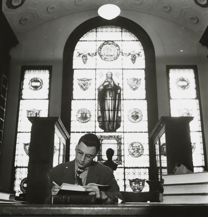 A man studying in a library, 1948.