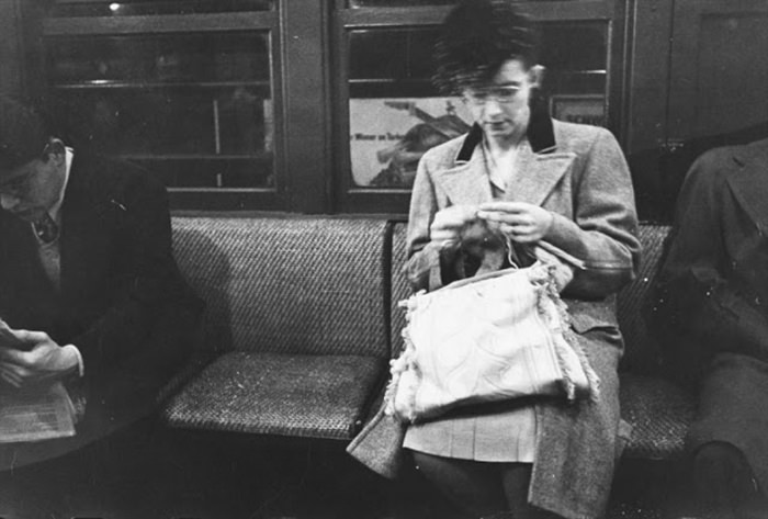 A woman knitting on a subway, 1946.