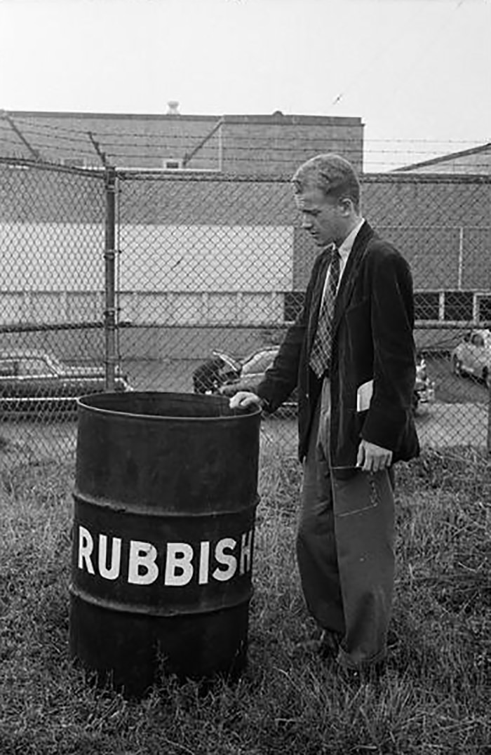 A man by a garbage can.