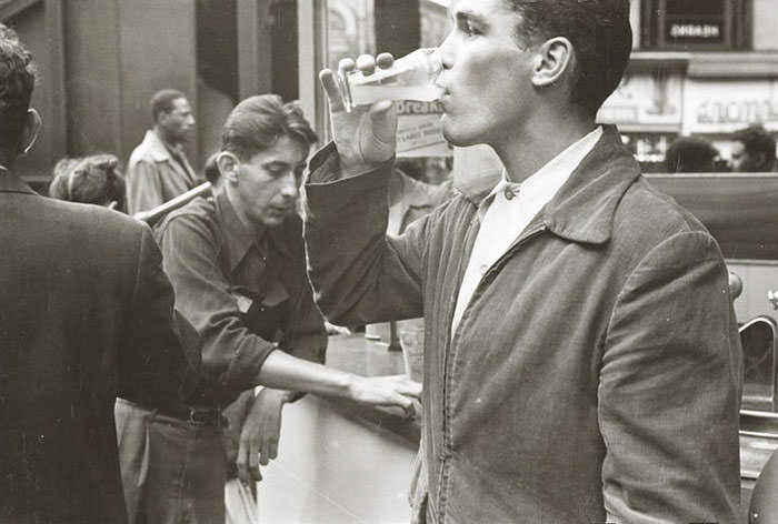 Walter Cartier drinking a beverage, 1948.